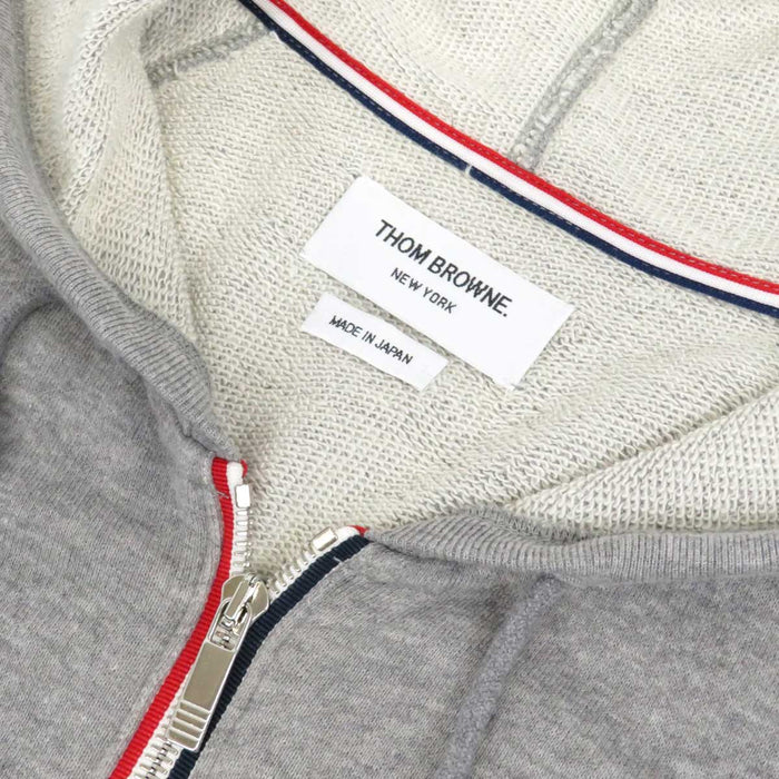 THOM BROWNE
Felpa con cappuccio con zip a righe in cotone
Completo felpa 4 BAR