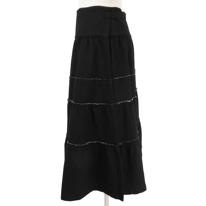 tricot COMME des GARCONS 
tricot COMME des GARCONS 
Gonna a portafoglio in lana con volant di lunghezza midi