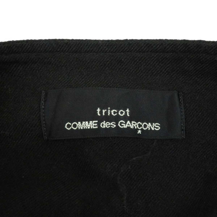 tricot COMME des GARCONS 
tricot COMME des GARCONS 
Gonna a portafoglio in lana con volant di lunghezza midi