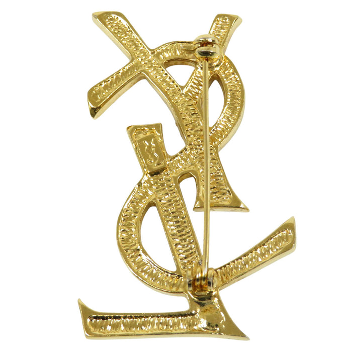 YVES SAINT LAURENT 
Metallo color oro 
Spilla con logo YSL e strass