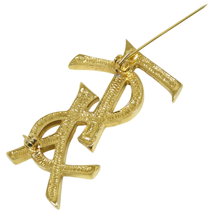 YVES SAINT LAURENT 
Metallo color oro 
Spilla con logo YSL e strass