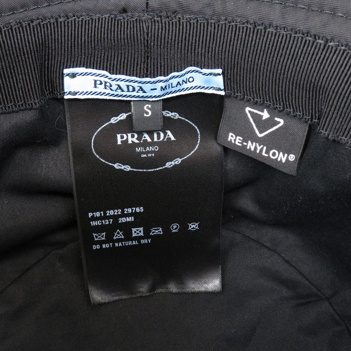 PRADA 
Triangle Logo Re-Nylon 
Re-Nylon Bucket Hat
