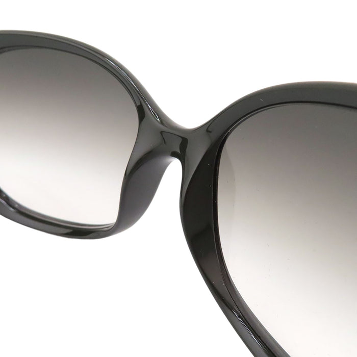 PRADA  
Lunettes  
Lunettes de soleil à branches avec logo triangulaire