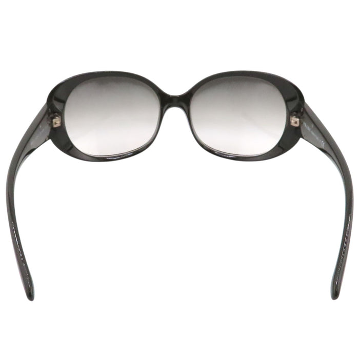 PRADA  
Lunettes  
Lunettes de soleil à branches avec logo triangulaire