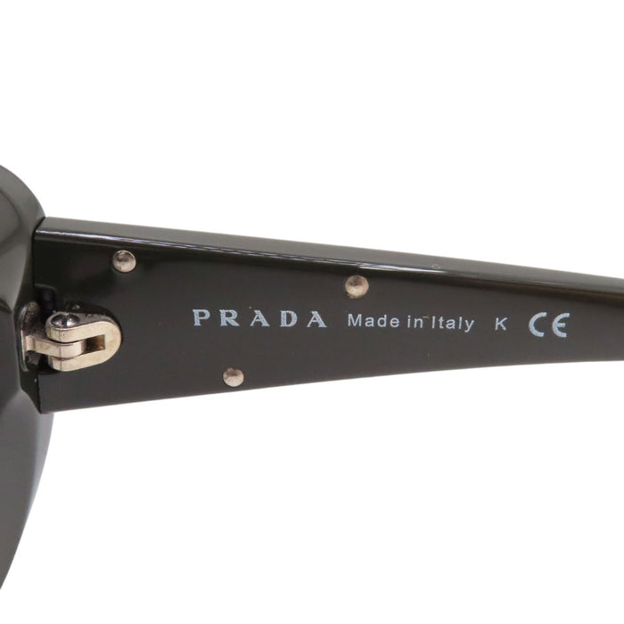 PRADA  
Lunettes  
Lunettes de soleil à branches avec logo triangulaire