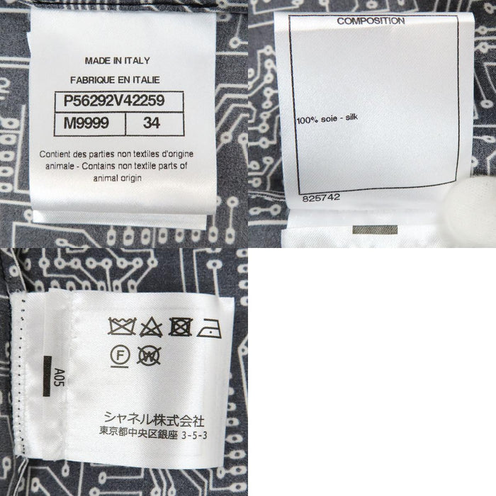 CHANEL  
COCO CC logo motif intégral bouton perle costume volant 17S  
Chemise manches longues en soie avec logo Coco