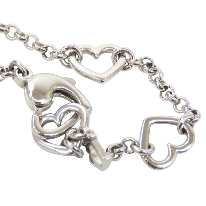 Dior 
Collier cœur ouvert et D ouvert avec logo et strass 
Fermoir couleur argent