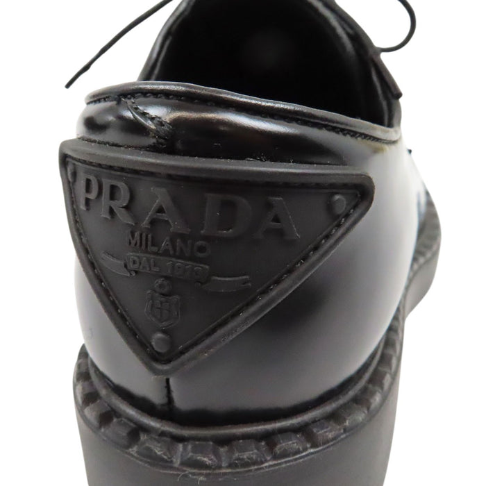 PRADA  
Derbies en cuir brossé à lacets avec plaque triangulaire  
Logo triangulaire