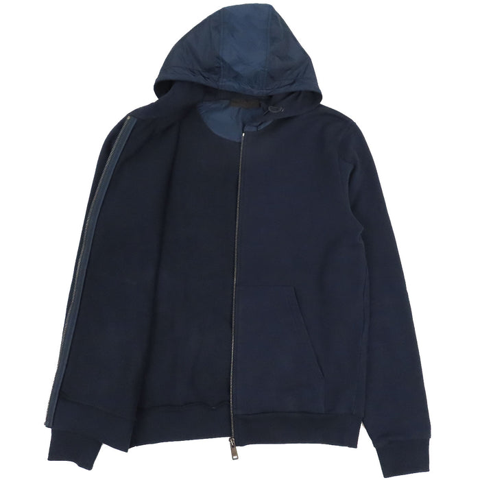 PRADA  
Sweat à capuche en coton avec logo en caoutchouc et empiècements en nylon  
Veste zippée avec logo latéral