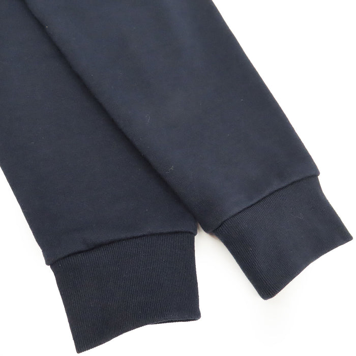 PRADA  
Sweat à capuche en coton avec logo en caoutchouc et empiècements en nylon  
Veste zippée avec logo latéral
