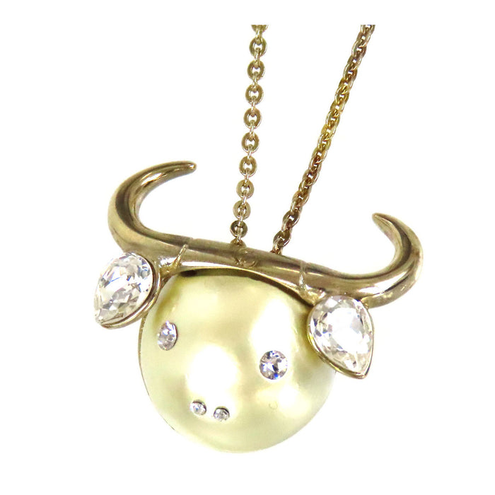 Dior 
Collier Tell Me Dior Taureau en métal doré avec logo, perles fantaisie et strass constellation