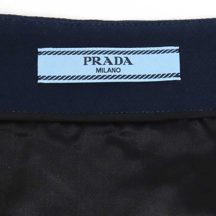 PRADA  
Gonna con bottoni logo e dettagli in metallo color oro, misto lana
