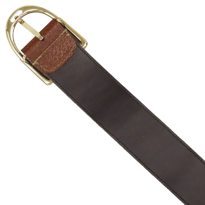 GUCCI  
All-over logo leather with gold-colored hardware  
GG canvas belt