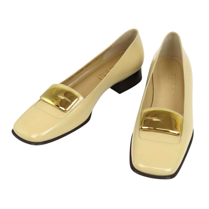 GUCCI 
Leather gold-colored metal square toe 
G logo patent pumps