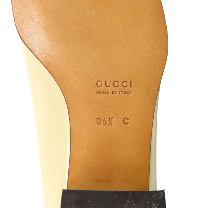 GUCCI 
Leather gold-colored metal square toe 
G logo patent pumps