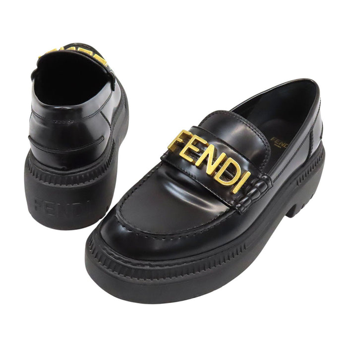 FENDI  
Logo leather gold-colored metal  
Graffiti loafers