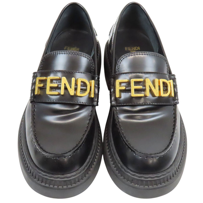 FENDI  
Logo leather gold-colored metal  
Graffiti loafers