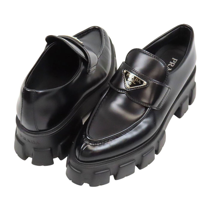 PRADA  
Triangle Logo Pointed Toe  
Monolith Brushed Leather Loafers