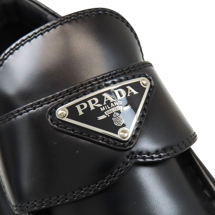 PRADA  
Triangle Logo Pointed Toe  
Monolith Brushed Leather Loafers