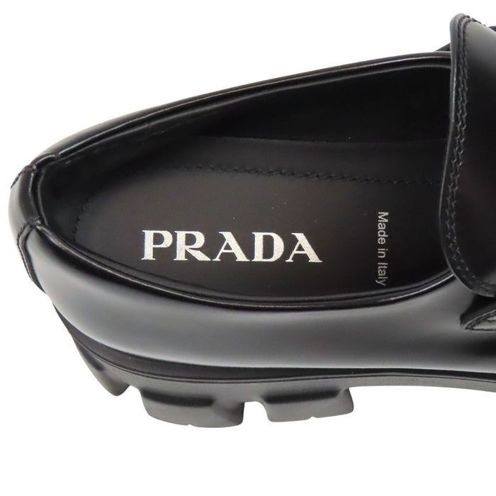 PRADA  
Triangle Logo Pointed Toe  
Monolith Brushed Leather Loafers