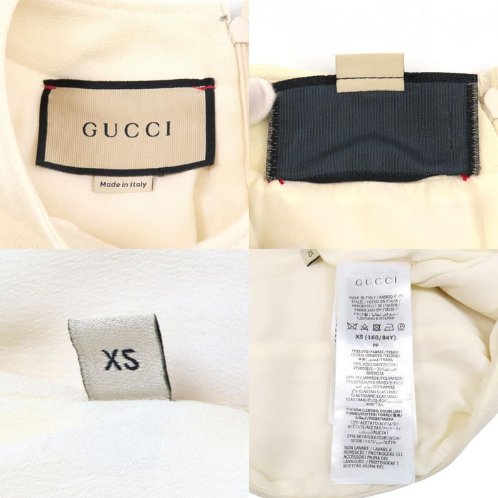 GUCCI  
Chain button with gold-colored hardware  
Double G short-sleeve dress