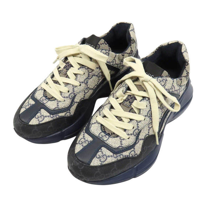 GUCCI 
All-over logo low-top lace-up 
GG Rhyton sneakers