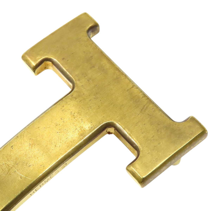 HERMES 
Ash Logo Gold-Tone Metal 
H Buckle